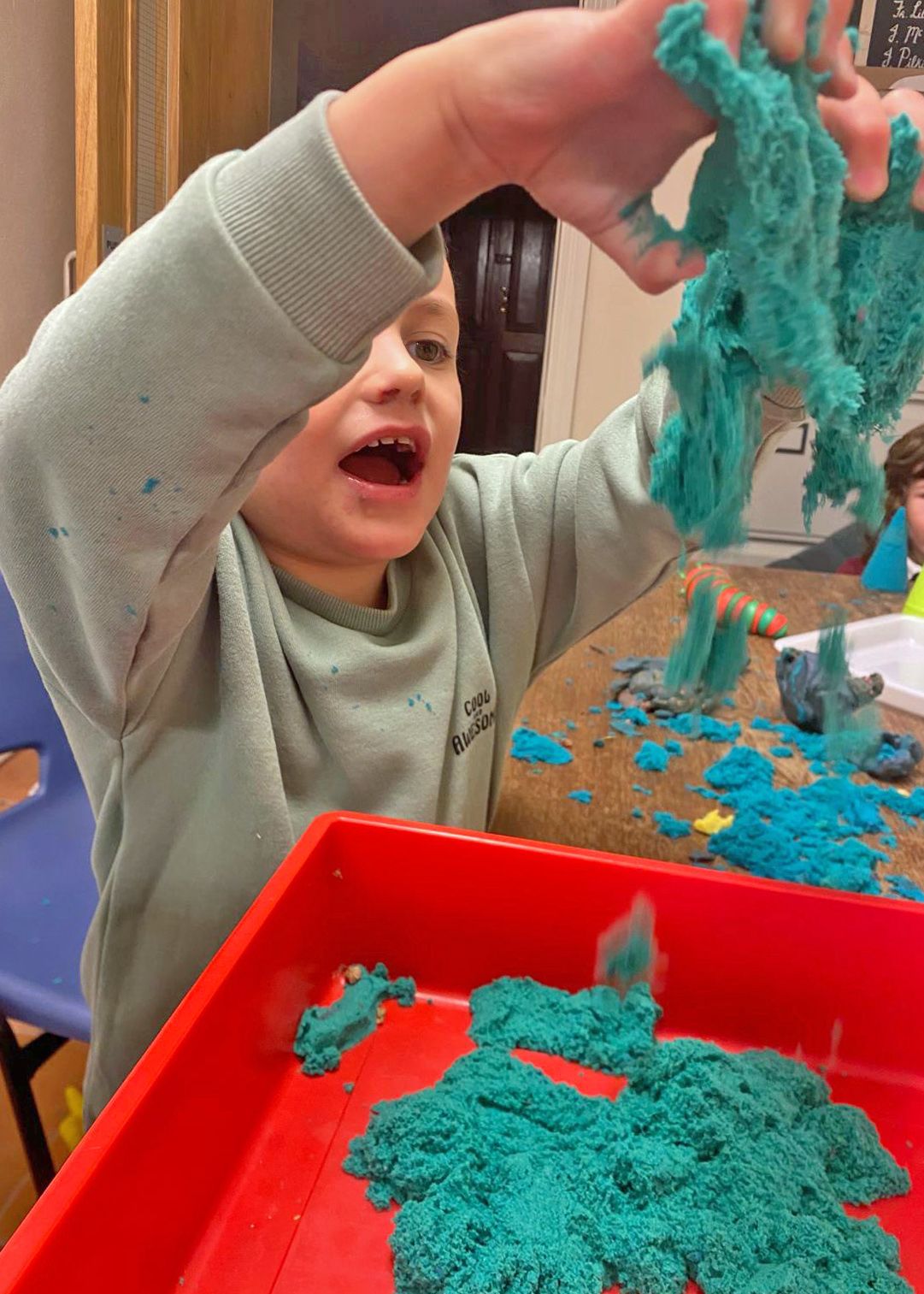child building an four boxes